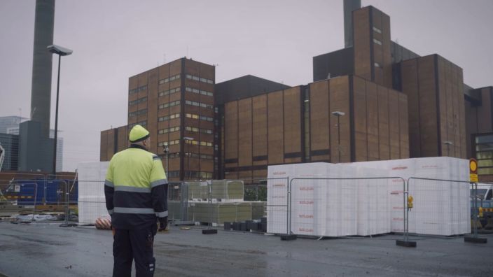 Worker looks on at closed electricity plant